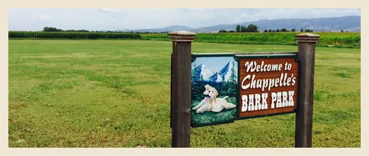 Welcome to Chappelle's Bark Park sign in a Fort Collins field